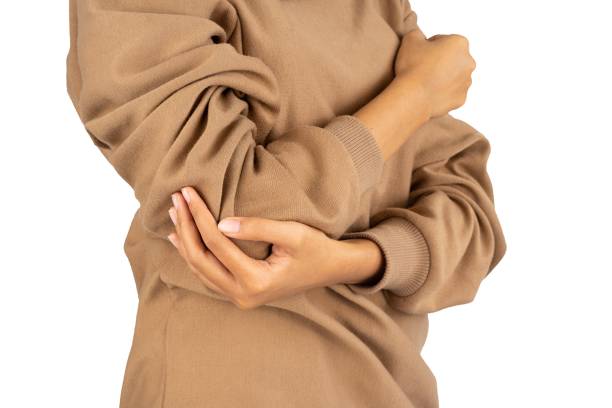 istock woman holding her sore elbow isolated 1490931255