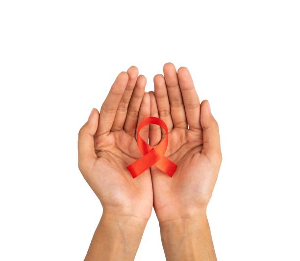 istock hands holding red ribbon. HIV AIDS awareness symbol 1490932775