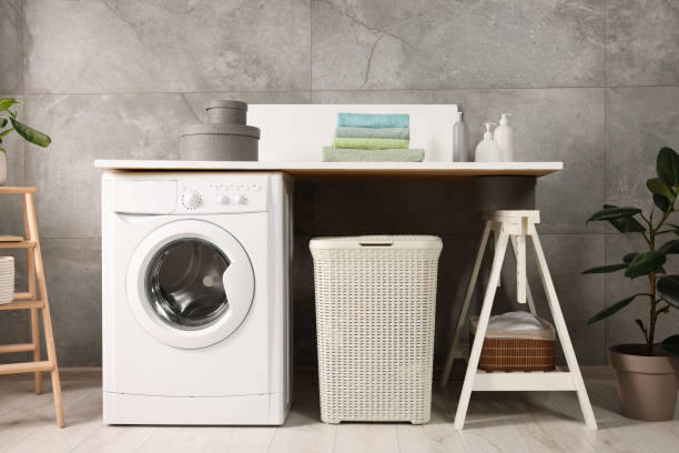 istock Stylish laundry room with modern washing machine. Interior design 1490933289