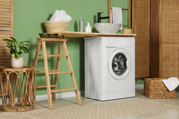 istock Stylish laundry room with functional washing machine. Interior design 1490933693