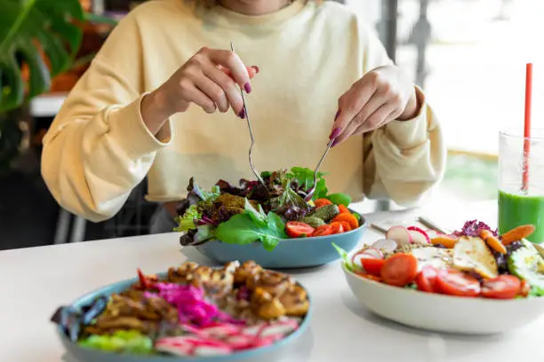 Photo of Woman eating healthy salad