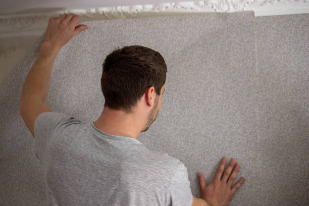 istock A man glues wallpaper, repairs the house. 1490934027