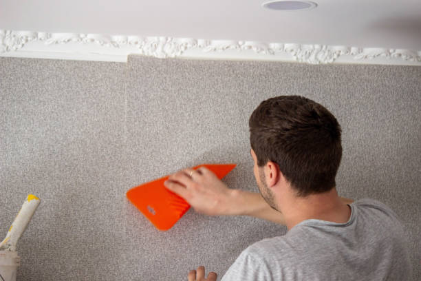 istock A man glues wallpaper, repairs the house. 1490934038