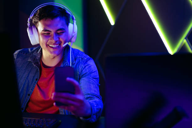 istock Happy young gamer watching live game broadcasts on a gaming app using his smartphone 1490935636