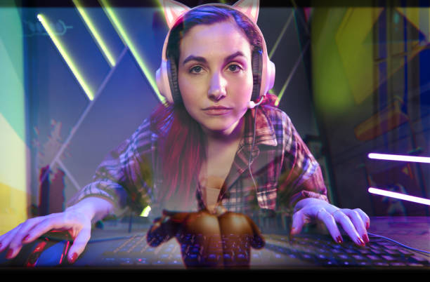 Female student using mouse to navigate computer screen while working on desktop PC in the computer lab