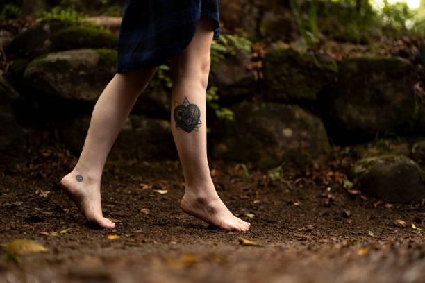 istock Feet of a person walking through a lush forest while 1490937003