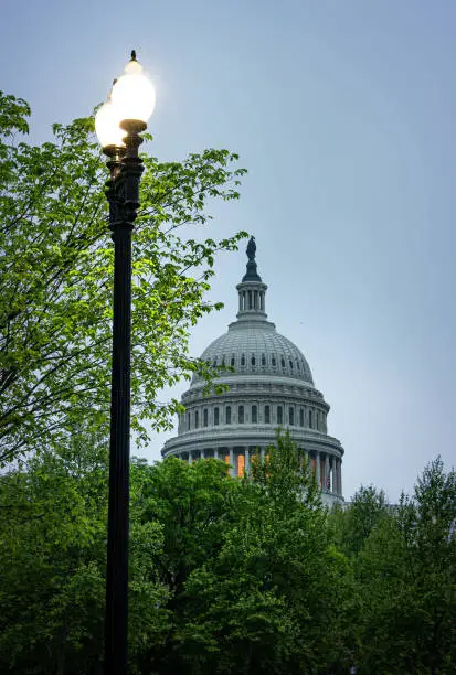 The United States Capitol Building in Washington D.C. during a spring season rain. Completed in 1800, the building serves as the home of the legislative branch of the United States government. Its iconic dome and neoclassical architecture are a symbol of American democracy and freedom.