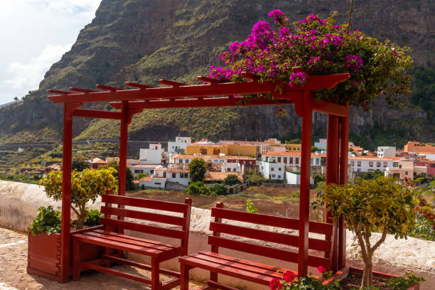 Red benches on the streets in the village of Agulo in the north of La Gomera in summer, Canary Islands Red benches on the streets in the village of Agulo in the north of La Gomera in summer, Canary Islands agulo stock pictures, royalty-free photos & images