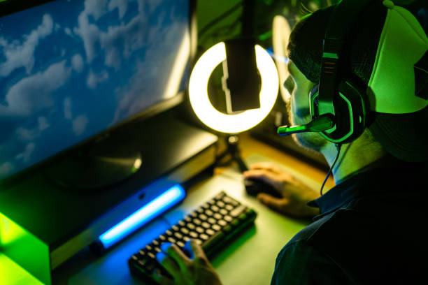 istock Close-up on a man playing videogames at home, live streaming. 1490942253