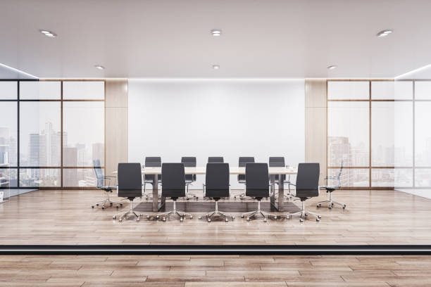 istock Front view on meeting table with black chairs on wooden floor and light wall background among windows with city view in modern conference room behind glass partition. 3D rendering 1490943163