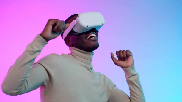 istock Smiling African-American man in vr headset dancing isolated over neon background 1490943455