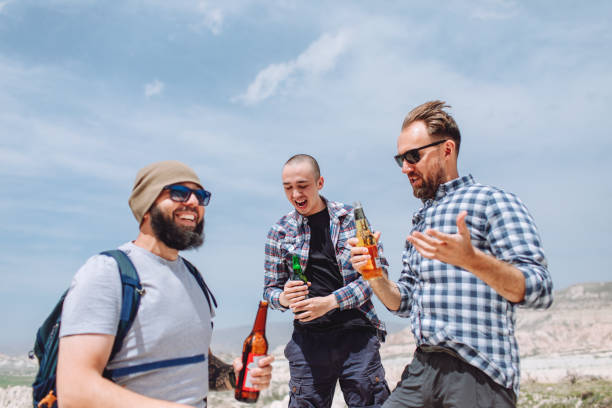 istock Happy three friends drinking beer in the mountains in Cappadocia 1490943677