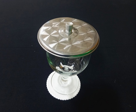 A glass cup on a black table.