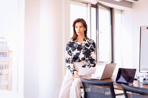 istock Thinking professional female standing in meeting room and deep in thought 1490946182