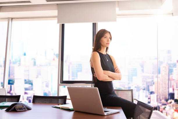istock Thinking professional female standing in a meeting room 1490946230