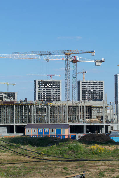 istock Construction site. Reinforced concrete frames of multi-storey buildings and construction cranes. Against the background of the blue sky. 1490946309