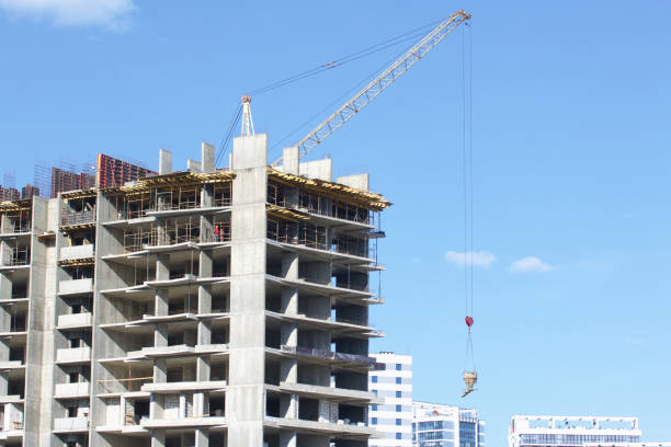istock Construction site. Reinforced concrete frames of multi-storey buildings and construction cranes. Against the background of the blue sky. 1490946902