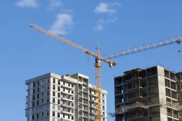 istock Construction site. Reinforced concrete frames of multi-storey buildings and construction cranes. Against the background of the blue sky. 1490947047