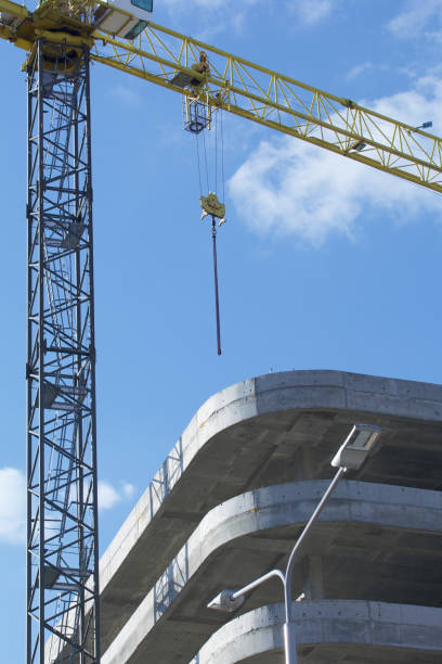 istock Construction site. Reinforced concrete frames of multi-storey buildings and construction cranes. Against the background of the blue sky. 1490947072