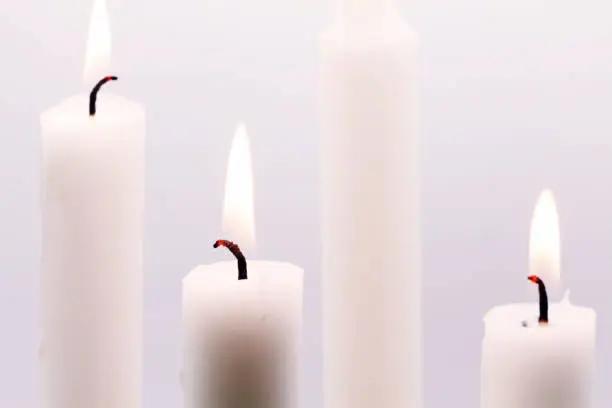three candles lit on the third Advent Sunday