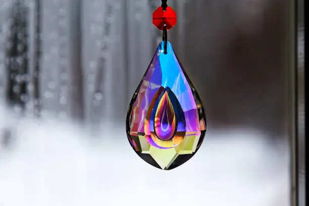 crystal in the colors of the rainbow against a gray and dull background