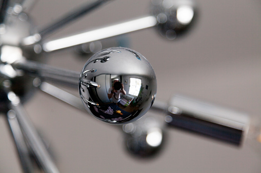 Umea, Norrland Sweden - April 17, 2022: silver ball for an interesting ceiling lamp