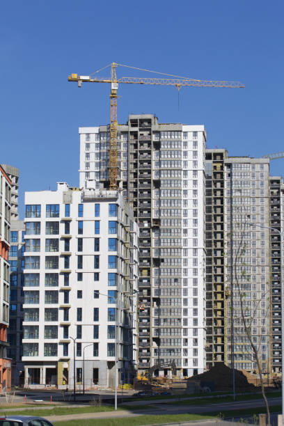 istock Construction site. Reinforced concrete frames of multi-storey buildings and construction cranes. The final stage of construction. Against the background of the blue sky. 1490948144
