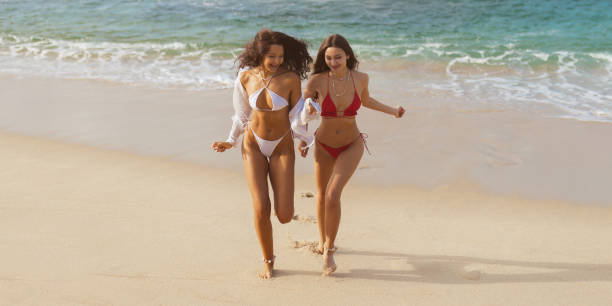 istock Two Young Women Enjoying a Summer Seaside Trip 1490951042