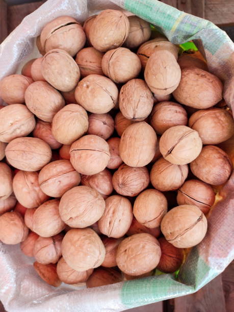 istock Unpeeled walnuts in bag are sold in a store 1490957530