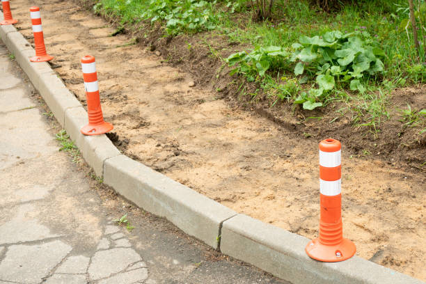 istock Construction of a footpath. Laying granite tiles on sandy ground and replacing sewer hatches. Improvement of urban areas and renewal of infrastructure 1490957574
