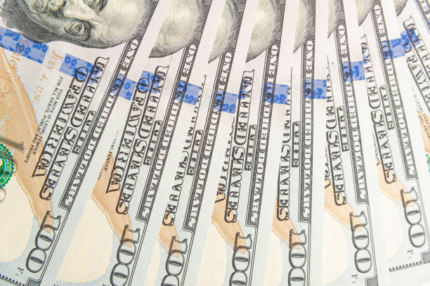 istock Wealth in Detail: Close-Up of Eight 100 Dollar Bills in Focus 1490959014