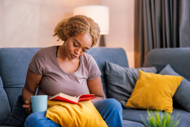 istock Woman relaxing at home, reading a book 1490959845