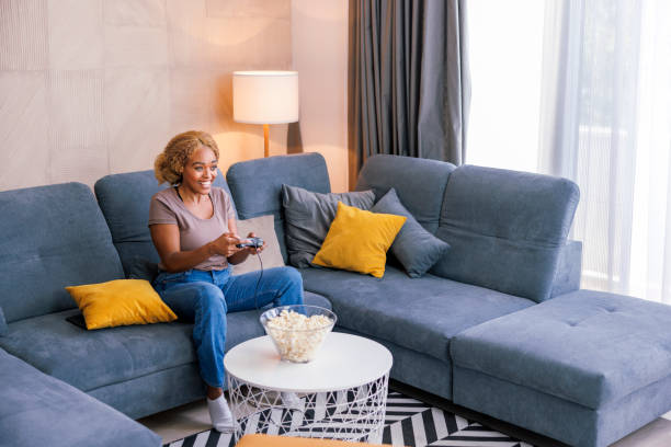 istock Woman having fun playing video games at home 1490959944