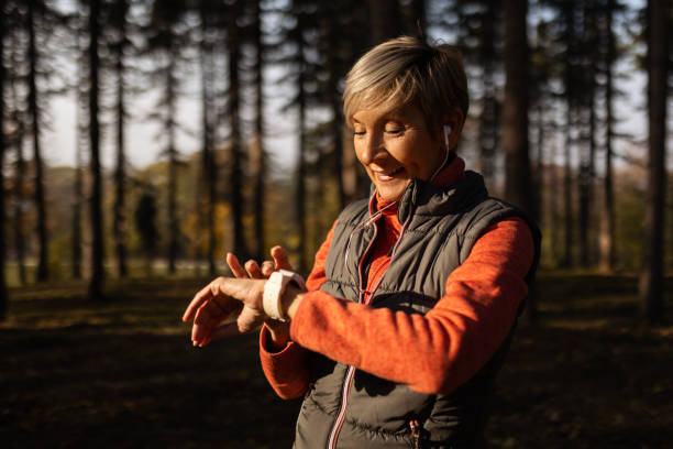 istock Senior woman looking at smart phone after running 1490960349