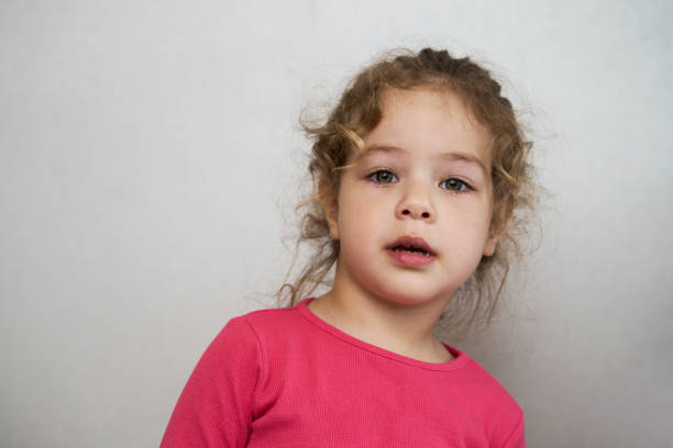 istock Cute little girl portrait on a grey background 1490962111