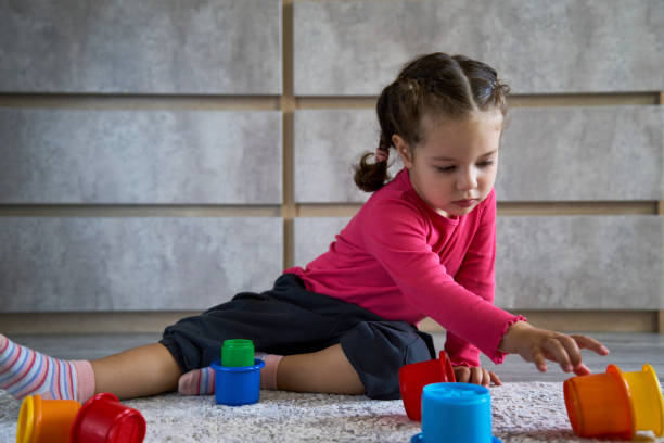istock Cute child playing colorful pyramid 1490962112