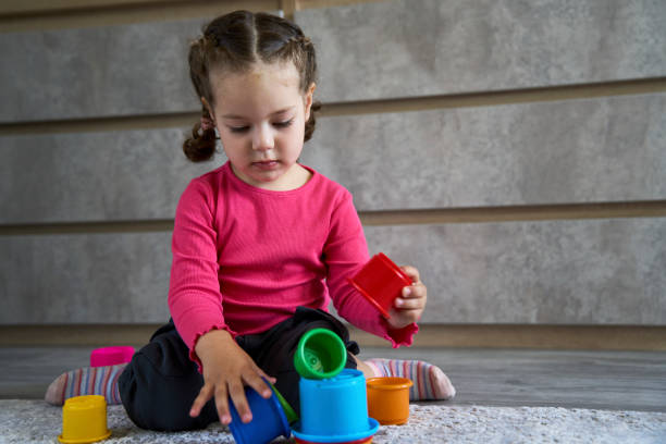istock Cute child playing colorful pyramid 1490962145