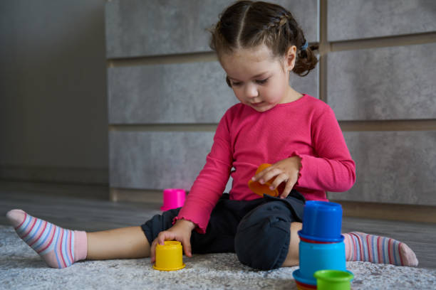 istock Cute child playing colorful pyramid 1490962153