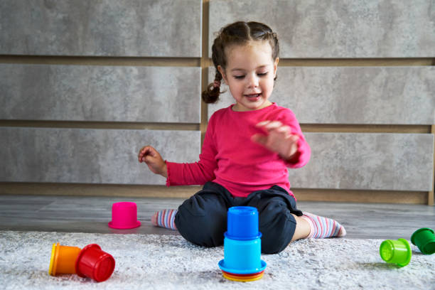 istock Cute child playing colorful pyramid 1490962158