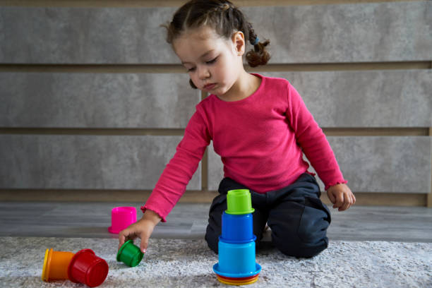 istock Cute child playing colorful pyramid 1490962170
