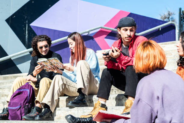 istock Young friends/students talking while study on a staircase at street 1490963182