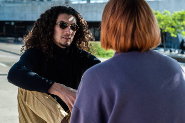 istock Young man talking with his friend at street 1490964610