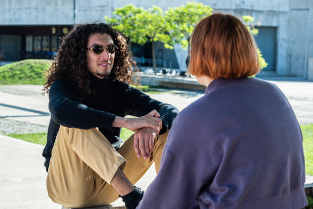 istock Young man talking with his friend at street 1490964611