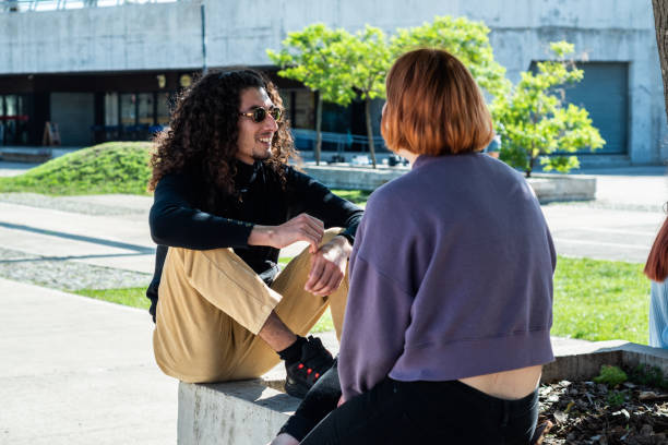 istock Young man talking with his friend at street 1490964612