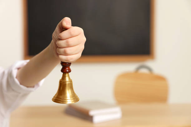 istock Boy ringing school bell in classroom, closeup. Space for text 1490965235