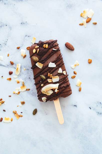 Vegan chocolate popsicle on stick. Summer dessert, plant-based concept.