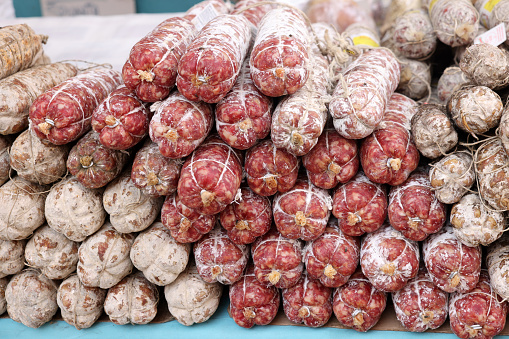 Traditional meat products sold at a street stall during the farmers market in Cremona, Lombardy, Italy