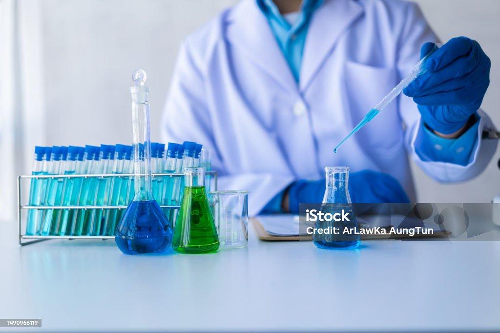medical science technology research in chemistry laboratory Test experiments in medical pharmaceuticals with glassware and blue liquid in test tubes. Analyzing Stock Photo