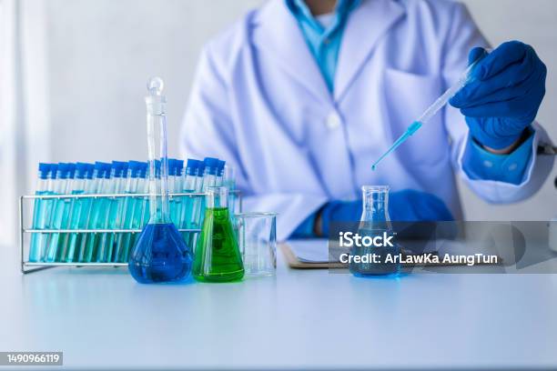 Medical Science Technology Research In Chemistry Laboratory Test Experiments In Medical Pharmaceuticals With Glassware And Blue Liquid In Test Tubes Stock Photo - Download Image Now