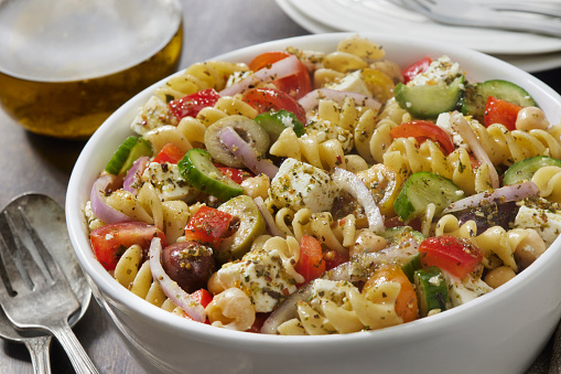 Greek Pasta Salad with Rotini, Feta, Cherry Tomatoes, Cucumber, Olives, Red Onion and Red Peppers